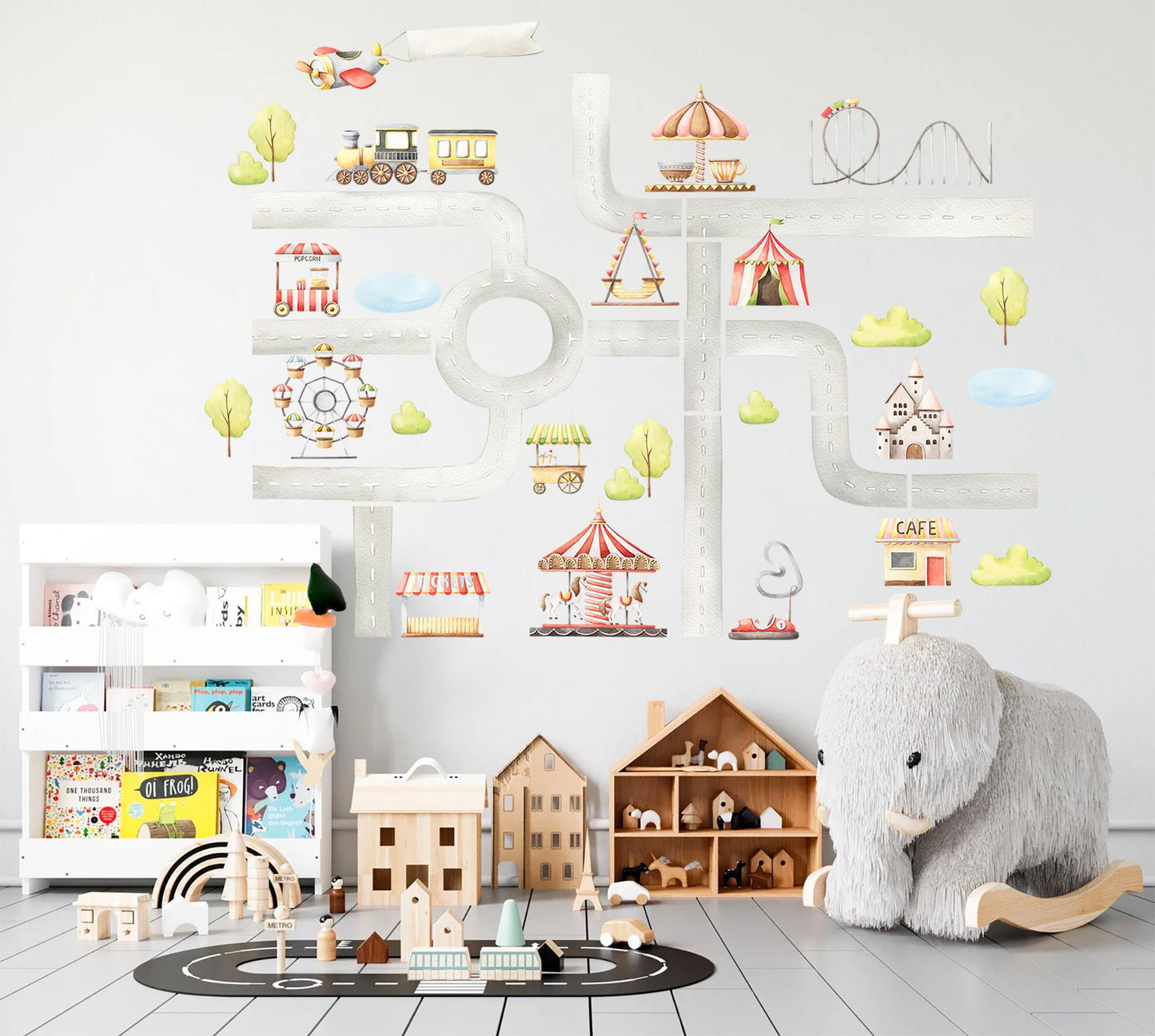 Playroom featuring amusement park themed wall stickers with pastel carnival elements like carousel, train, and circus tents on a playful road map design.