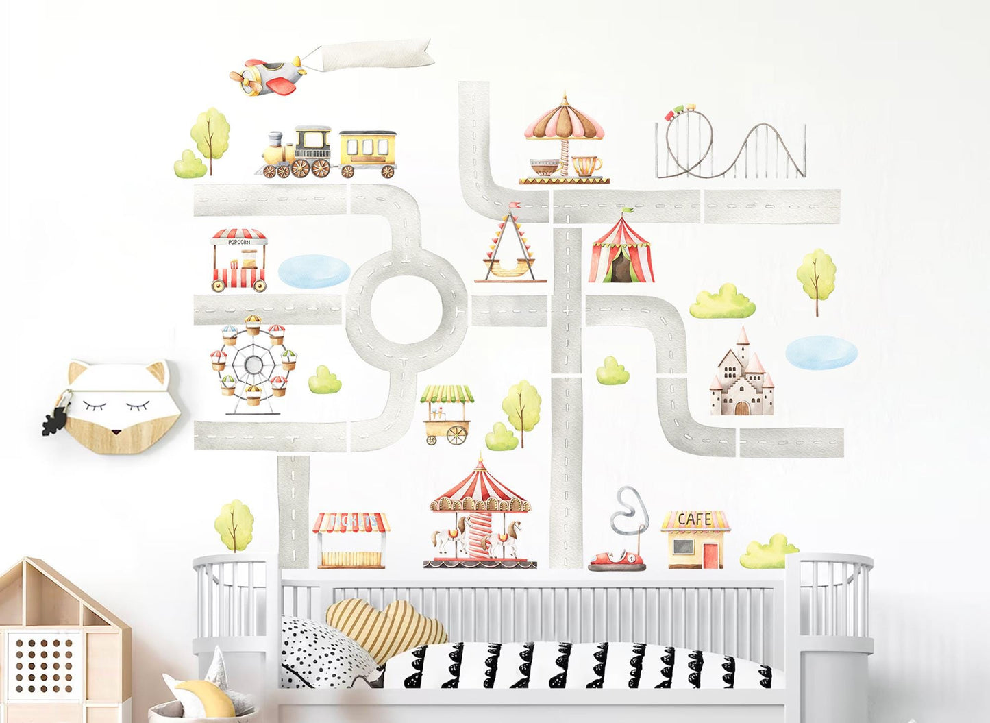 Nursery room wall decorated with colorful amusement park decals, including carnival rides, circus tents, ferris wheel, roller coaster, and playful road design.