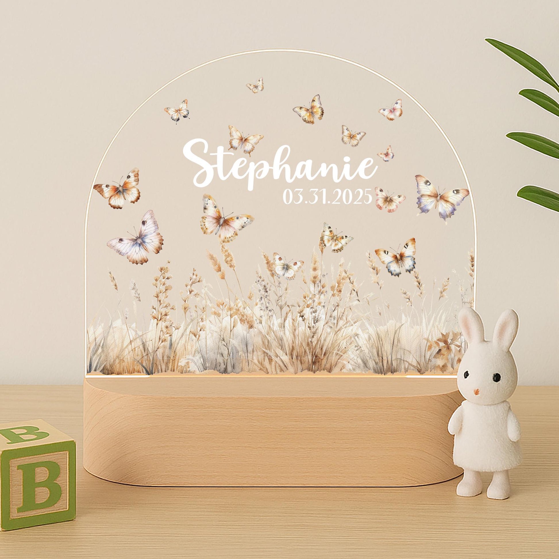 Butterfly meadow night light glowing warm white in nursery